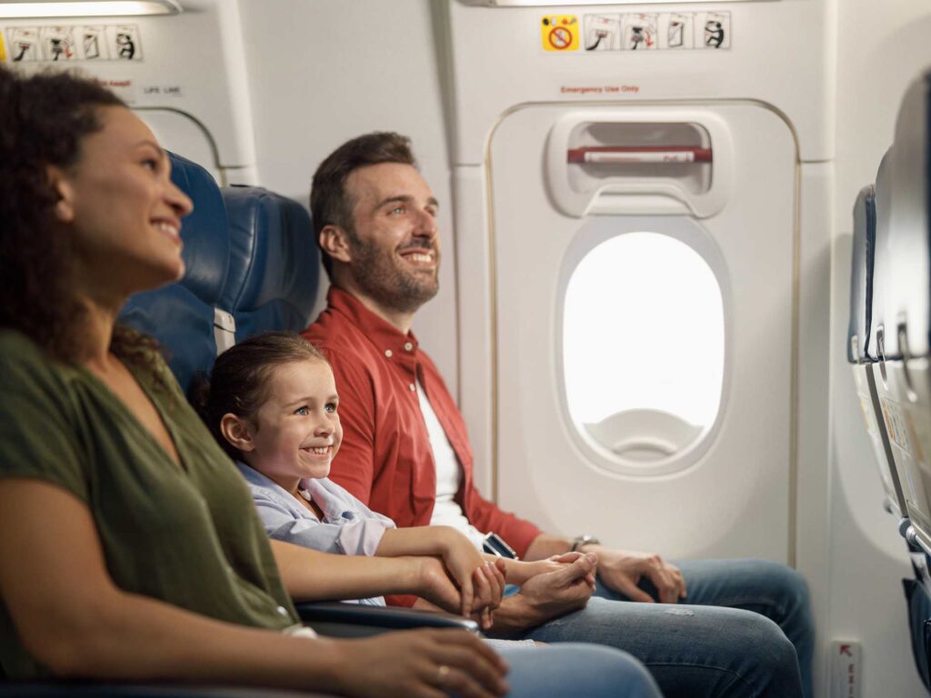 family of three enjoying free flights in economy