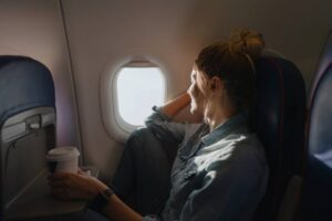 woman enjoying the view out the plane window