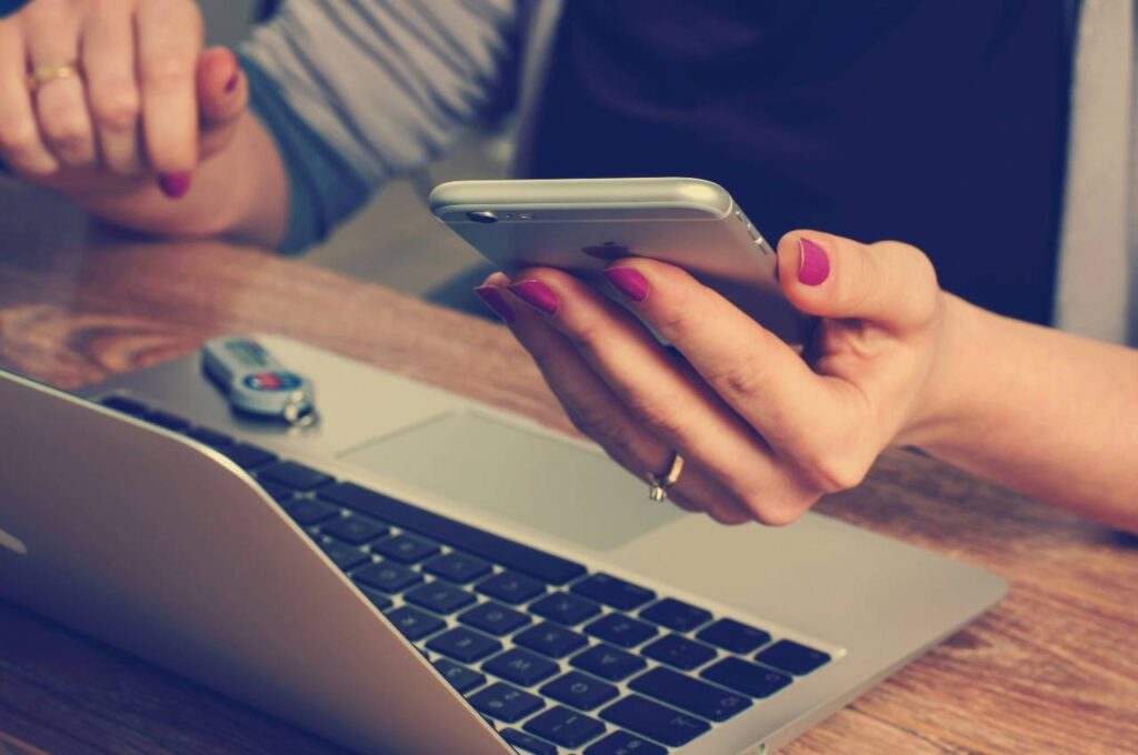 person using laptop and phone