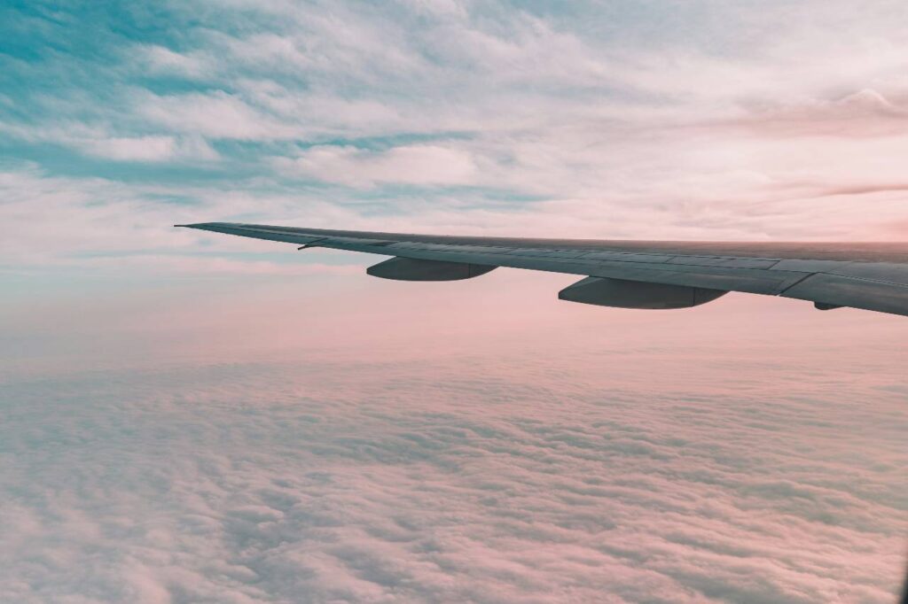 plane flying above clouds