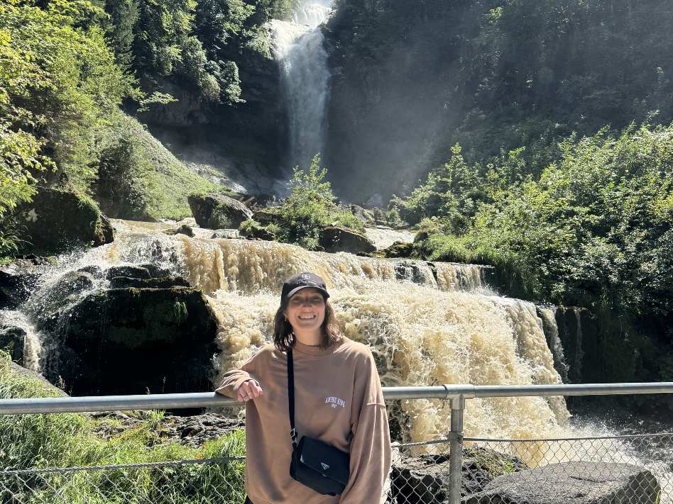 author in front of a waterfall