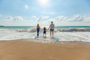 family standing on beach