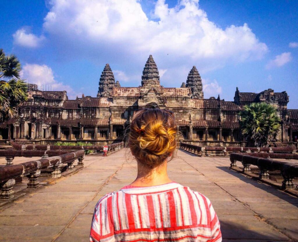 traveler in front of Angkor Wat